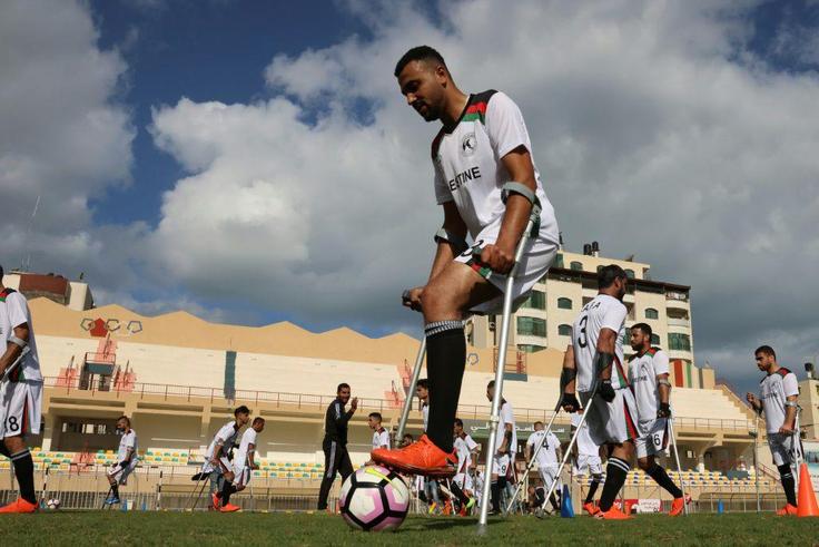 Palestinian players with disabilities, part of a football team organised by the International Committee of the Red Cross, take part in a training session in Gaza City