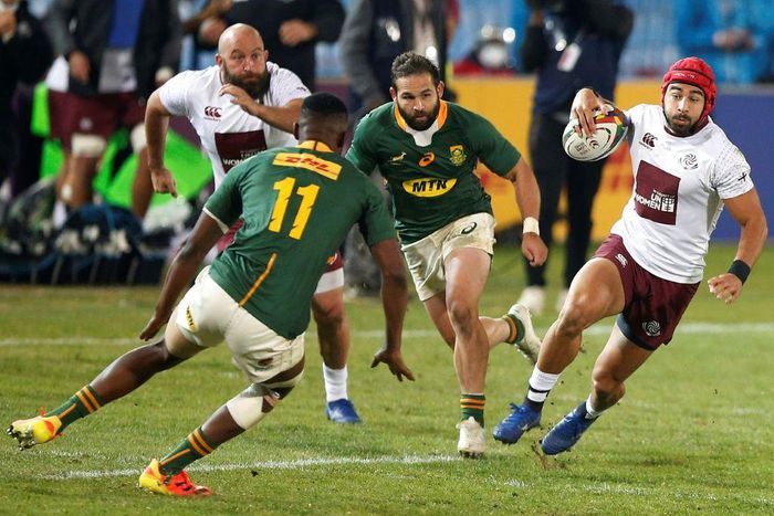 Georgia wing Akaki Tabutsadze (R) runs with the ball in a Test against South Africa on Friday in Pretoria.