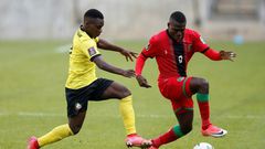 Midfielders Luis Miquissone (L) of Mozambique and John Banda (R) of Malawi contest possession during a World Cup qualifier in Soweto on Tuesday