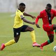 Midfielders Luis Miquissone (L) of Mozambique and John Banda (R) of Malawi contest possession during a World Cup qualifier in Soweto on Tuesday