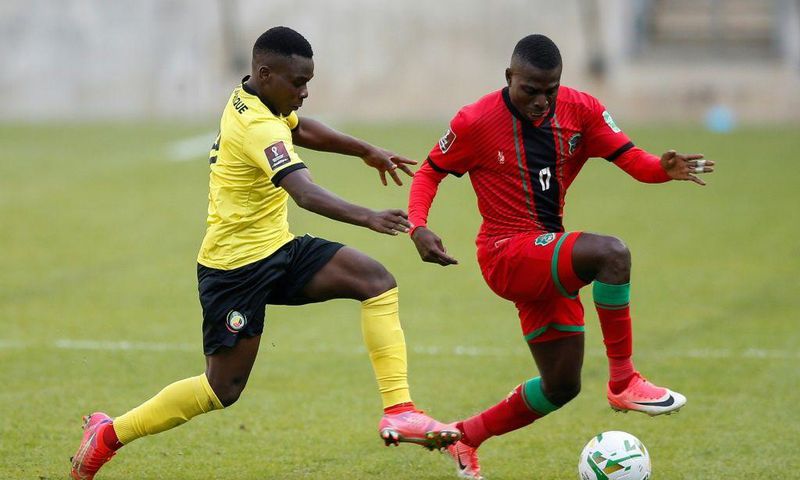Midfielders Luis Miquissone (L) of Mozambique and John Banda (R) of Malawi contest possession during a World Cup qualifier in Soweto on Tuesday