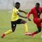 Midfielders Luis Miquissone (L) of Mozambique and John Banda (R) of Malawi contest possession during a World Cup qualifier in Soweto on Tuesday