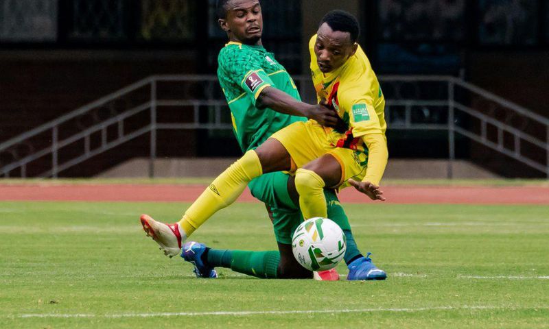 Zimbabwe forward Khama Billiat (R) contests possession with South Africa midfielder Teboho Mokoena (L) during a 2022 World Cup qualifier in Harare