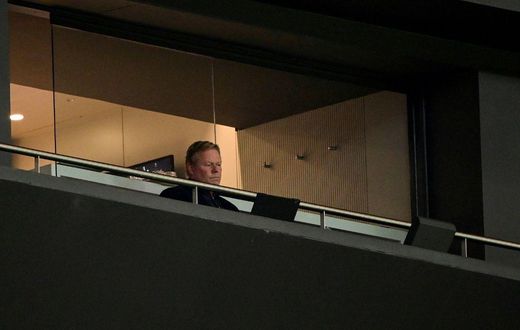 Lonely life: Barcelona coach Ronald Koeman looks on from the stands