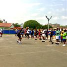 Kojo Afari tutoring the athletes in some basic basketball techniques