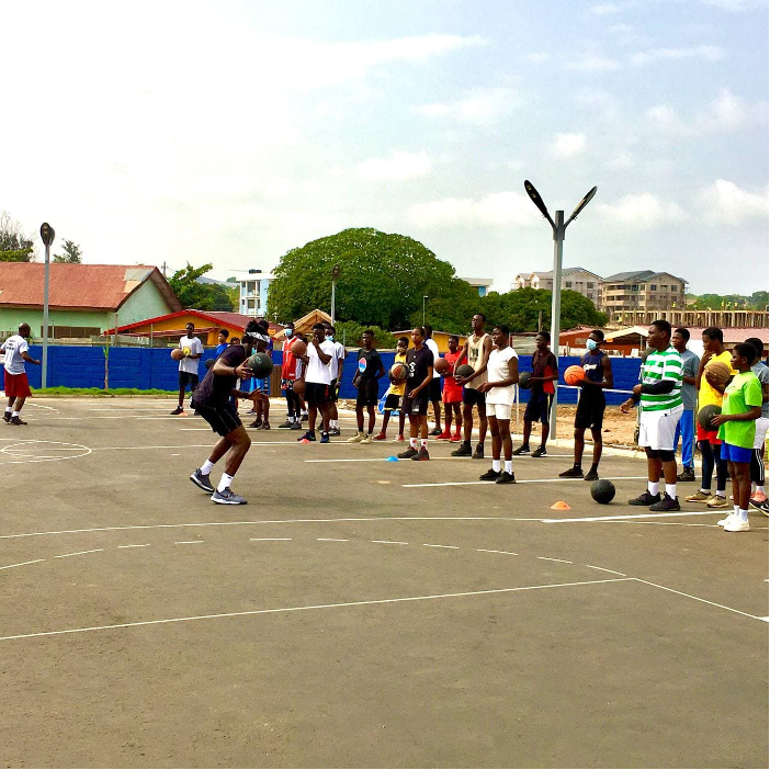 Kojo Afari tutoring the athletes in some basic basketball techniques