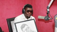 Castro Under Fire receives a portrait during a radio interview in 2014