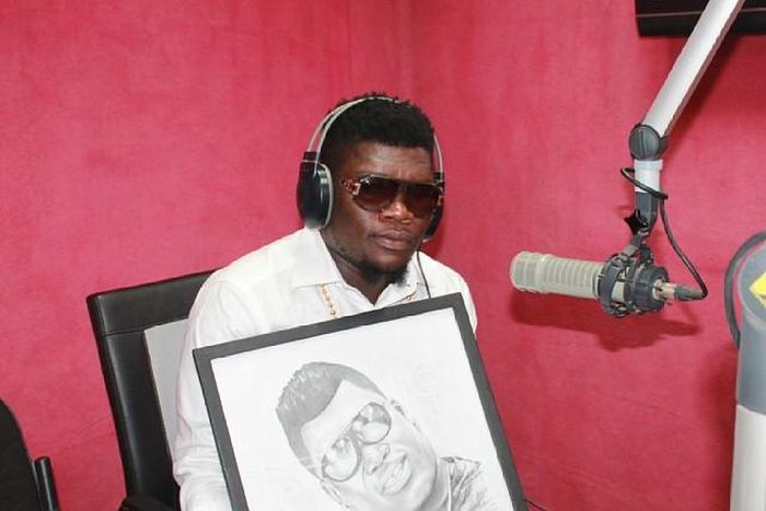 Castro Under Fire receives a portrait during a radio interview in 2014