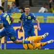 Mykola Shaparenko (L) wheels away in celebration after scoring for Ukraine