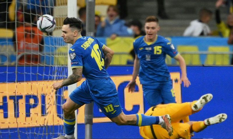 Mykola Shaparenko (L) wheels away in celebration after scoring for Ukraine