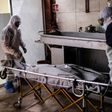Mortuary workers move the body of a COVID-19 victim at a crematorium in Cuautitlan Izcalli, Mexico State