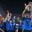 Italy midfielder Manuel Locatelli holding the Euro 2020 trophy.