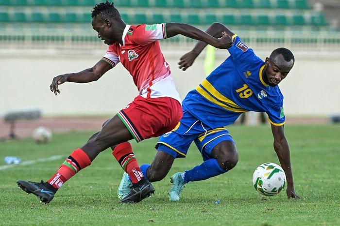 Timothy Ouma (L) of Kenya and Danny Usengimana (R) of Rwanda fight for the ball during a World Cup qualifier in Nairobi on Monday