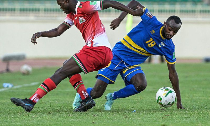 Timothy Ouma (L) of Kenya and Danny Usengimana (R) of Rwanda fight for the ball during a World Cup qualifier in Nairobi on Monday