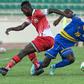 Timothy Ouma (L) of Kenya and Danny Usengimana (R) of Rwanda fight for the ball during a World Cup qualifier in Nairobi on Monday