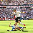 Stewart Downing dribbling past Paraguayan defender Denis Caniza at the 2006 World Cup in Germany