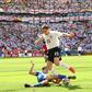 Stewart Downing dribbling past Paraguayan defender Denis Caniza at the 2006 World Cup in Germany