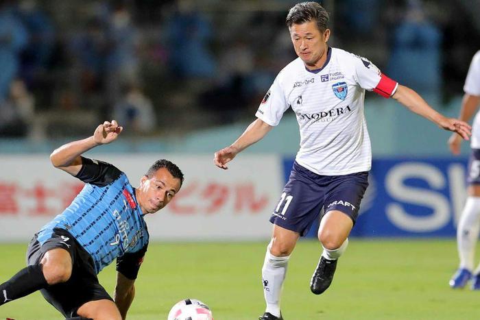 Japanese footballer Kazuyoshi Miura (right) says he wants to continue playing at the age of 54