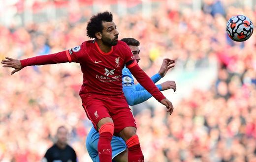 Egypt star Mohamed Salah (L) wins a heading duel during the Premier League draw between Liverpool and Manchester City at the weekend.