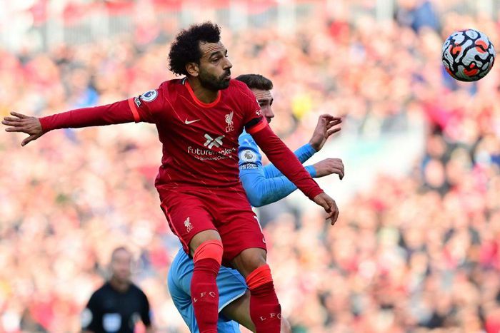 Egypt star Mohamed Salah (L) wins a heading duel during the Premier League draw between Liverpool and Manchester City at the weekend.