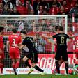 Bayern Munich striker Robert Lewandowski (C) celebrates after scoring from a free-kick at Union Berlin on Saturday
