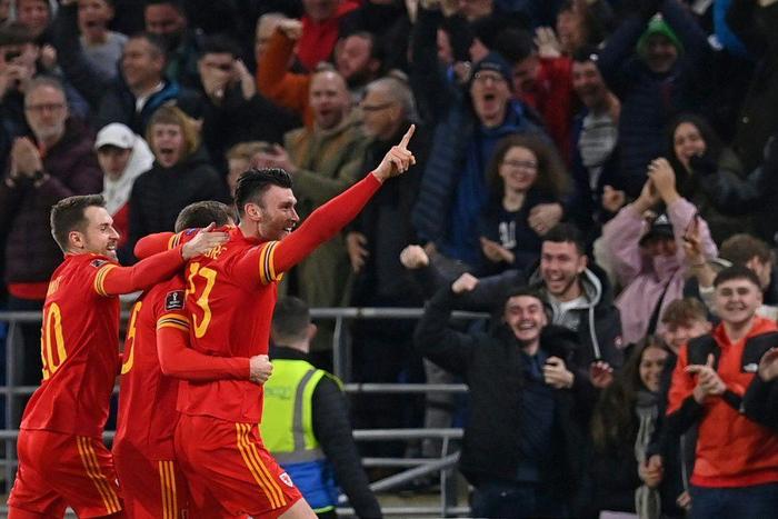 Wales striker Kieffer Moore (R) celebrates after scoring against Belgium