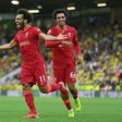 Mohamed Saleh (L) celebrates his goal for Liverpool at Norwich on the opening weekend of the English Premier League season