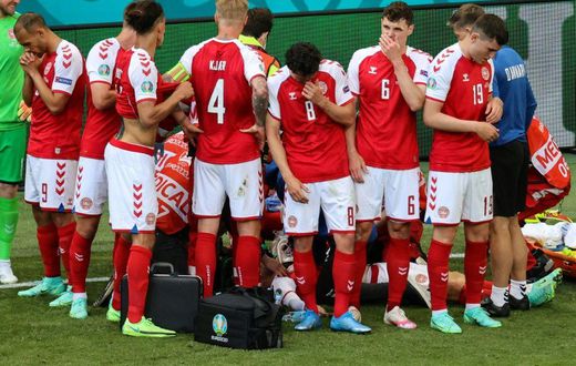Denmark's players formed a protective ring around Christian Eriksen after he suffered a cardiac arrest in their opening match of Euro 2020 against Finland