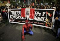Hundreds of people marched over the weekend towards the seats of government in central Lima under a heavy police presence. [Sebastian Castaneda/Reuters]