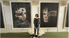 Ai-Da Robot in front of their AI-created “AI-God”. Picture: EPA/SOTHEBY'S