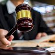 A judge uses a gavel in a courtroom.Naruecha Jenthaisong/Getty Images