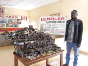 A suspect pictured with illicit drugs intercepted by NDLEA