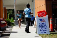 Voters walk to cast their ballots during early voting in the presidential election at a polling station in Tampa, Florida. REUTERS/Octavio Jones