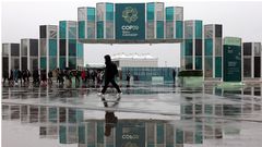 People walk at the entrance of the venue of the United Nations climate change conference COP29, in Baku, Azerbaijan. REUTERS/Murad Sezer