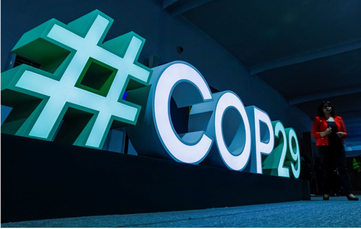 A woman passes by a #COP29 sign during the United Nations climate change conference COP29 in Baku. REUTERS/Maxim Shemetov