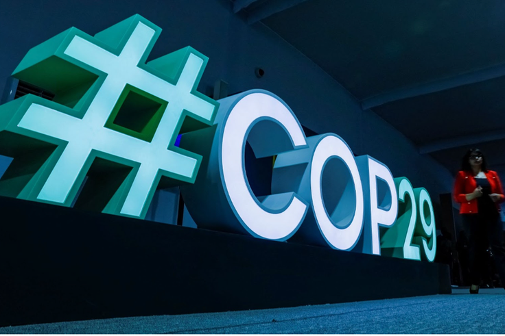 A woman passes by a #COP29 sign during the United Nations climate change conference COP29 in Baku. REUTERS/Maxim Shemetov