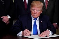 File photo: U.S. President Donald Trump signs a memorandum on tariffs on high-tech goods from China, at the White House in March 2018.REUTERS/Jonathan Ernst