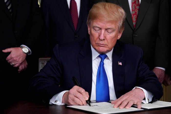 U.S. President Donald Trump signs a memorandum on tariffs on high-tech goods from China, at the White House in March 2018.REUTERS/Jonathan Ernst