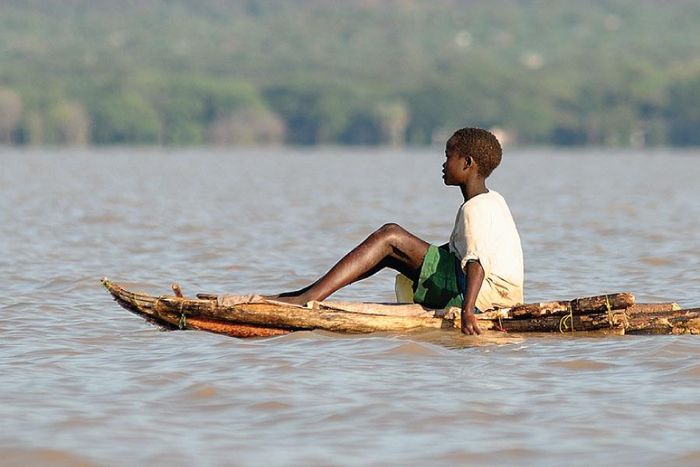 A boy floats on a locally made canoe across Lake Baringo. (eastafricanjunglesafaris.)