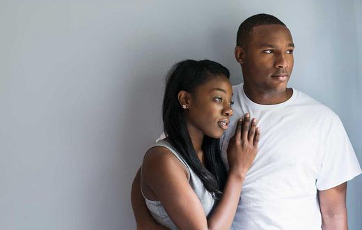A man and woman embrace each other [Source: Essence]