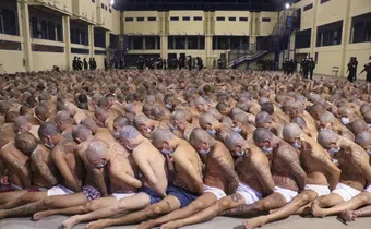 Inmates are lined up during a security operation under the watch of police at Izalco prison in San Salvador, El Salvador, on April 25, 2020. © 2020 El Salvador presidential press office via AP