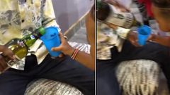 Screenshots from a video which circulated online showing an adult giving whiskey to a 3-year-old child.