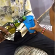 Screenshots from a video which circulated online showing an adult giving whiskey to a 3-year-old child.