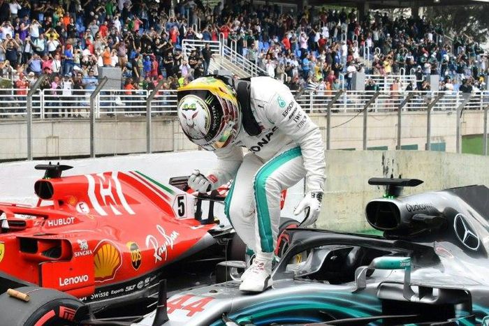 Lewis Hamilton celebrates after taking pole position