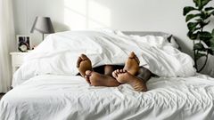 Black couple lying on bed together sex concept