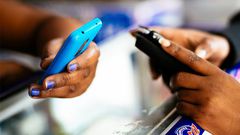 Stock photo of people holding phones