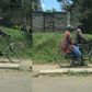 Elderly man taking his sick wife to the hospital on a bicycle sparks reactions