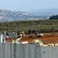 Israeli soldiers deploy excavators alongside the border wall with Lebanon on December 5, 2018, after the army announced it had discovered Hezbollah infiltration tunnels passing under it