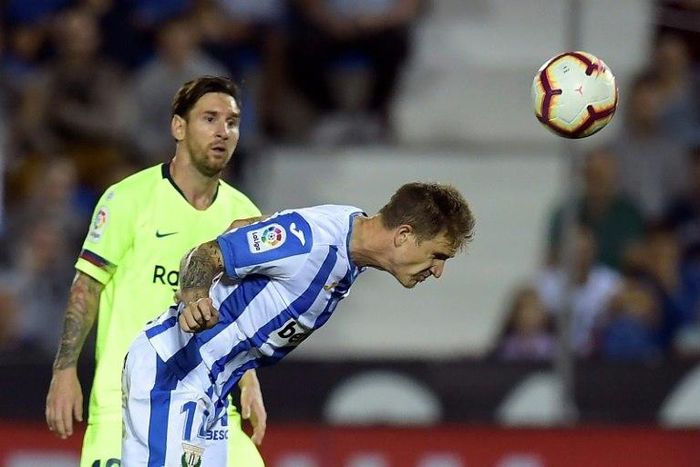 Watch this! Barcelona's Lionel Messi looks on as Leganes defender Raul Garcia clears the ball