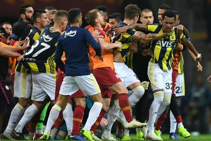 Fenerbahce and Galatasaray players fight at the end of the Turkish Spor Toto Super league fotball match between Galatasaray and Fenerbahce